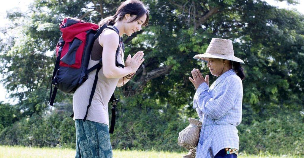 A female tourist greeting a local woman